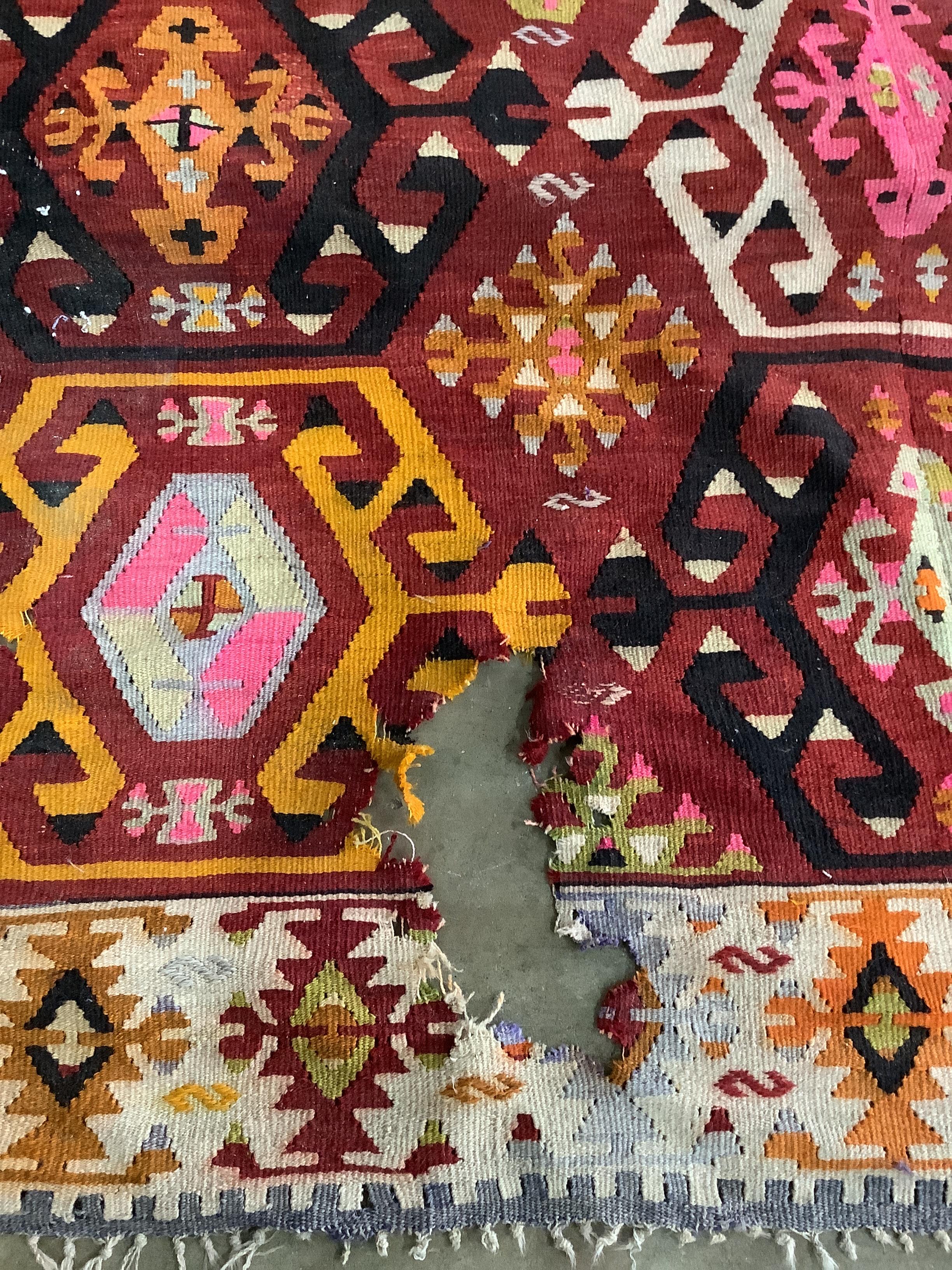 A Kilim polychrome flatweave carpet, approx. 400 x 380cm